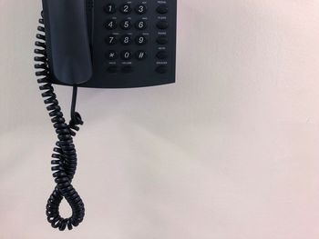 High angle view of telephone on table against wall