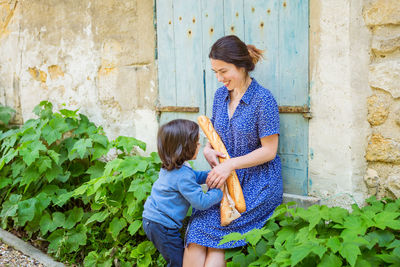 Mother and little handsome baby boy walking outdoor in park