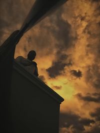 Low angle view of silhouette man against sky during sunset