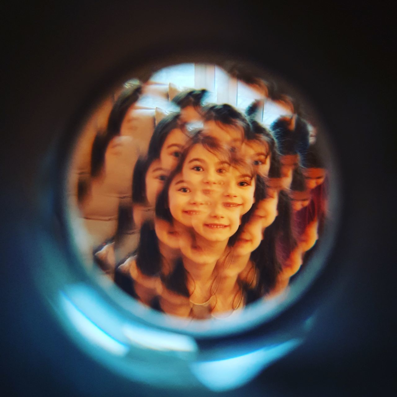 CLOSE-UP PORTRAIT OF SMILING YOUNG WITH HOLE IN CONTAINER