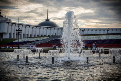 View of fountain in sea against cloudy sky