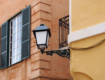 Low angle view of street light against building