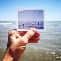 Cropped image of man standing by sea