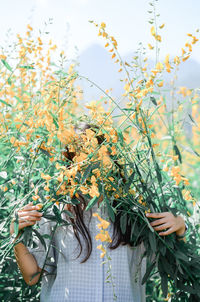 Woman standing amidst flowering plants