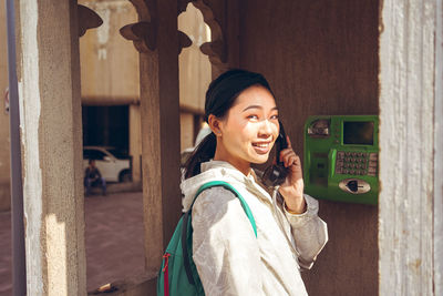Portrait of smiling young woman standing outdoors