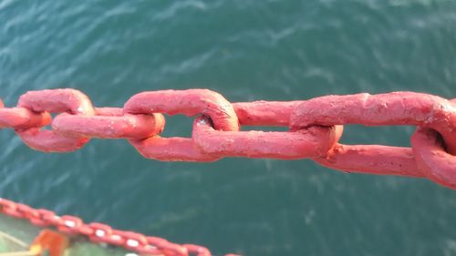 Close-up of chain against sea