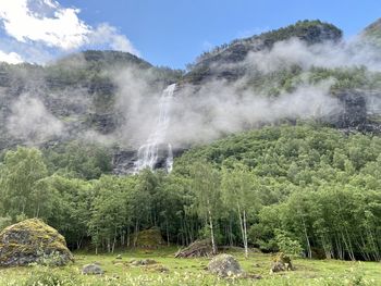 Scenic view of waterfall against sky