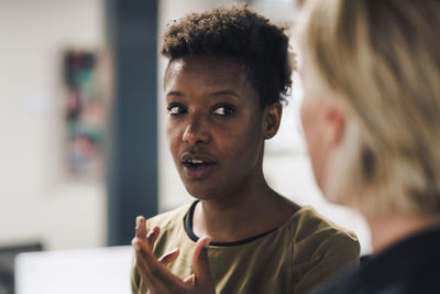 Businesswoman explaining colleague in office