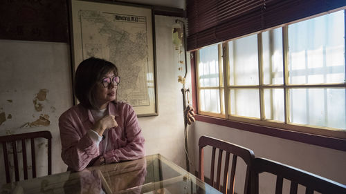 A woman sitting near window