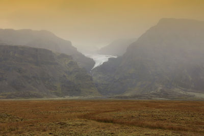 Scenic view of glacier against sky