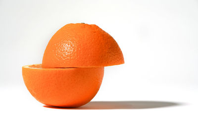 Close-up of orange fruit against white background