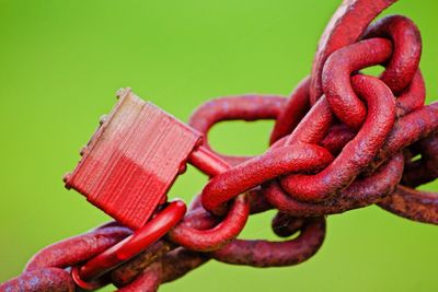 Close-up of rusty metal against green background