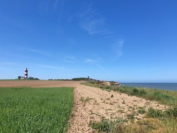 Scenic view of sea and lighthouse against sky