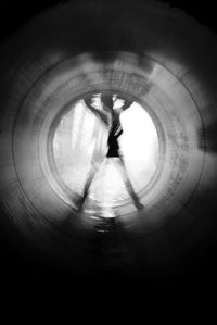 Woman jumping in tunnel