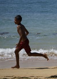 Woman jumping in sea