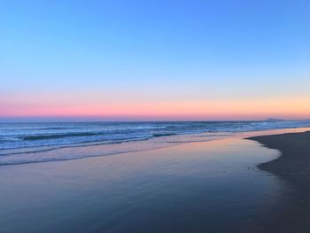 Scenic view of beach at sunset