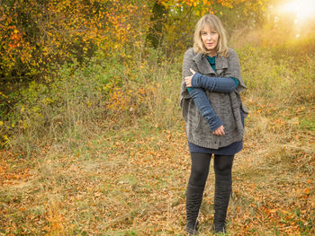 Portrait of woman standing in forest