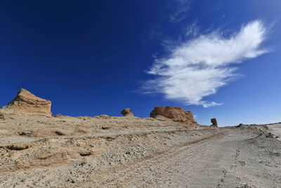 Rock formations in desert against blue sky