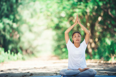 Young woman practicing yoga in at park