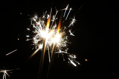 Low angle view of firework display at night