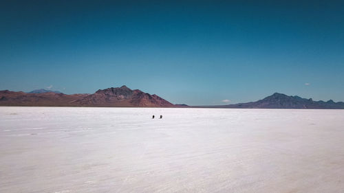 Scenic view of desert against blue sky