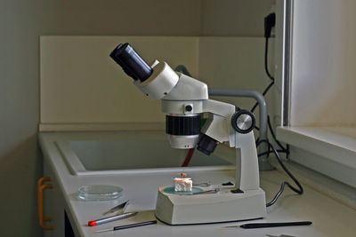 Close-up of microscope on table in laboratory