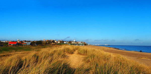 Scenic view of sea against clear blue sky