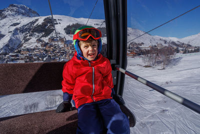 Portrait of boy standing on snow