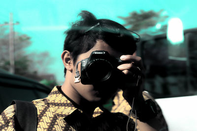 Portrait of woman photographing