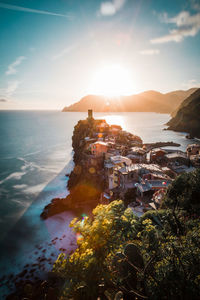 Vernazza, italy. high angle view of townscape by sea against sky during sunset