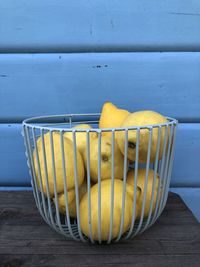 Close-up of fruits on table against wall