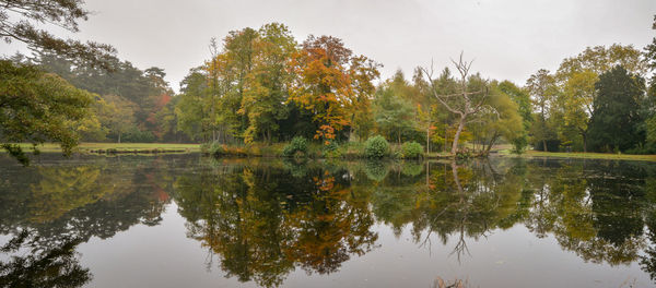 Reflection of trees in lake against sky