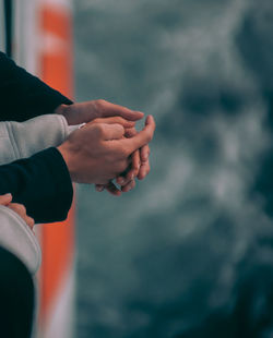 Couple holding hand while traveling in ship