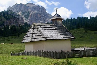 Built structure on field against mountains