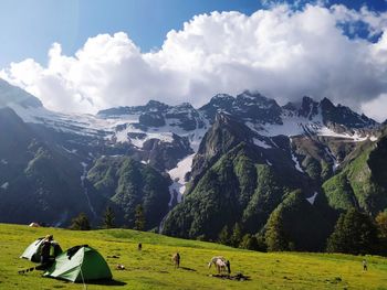 Panoramic view of snowcapped mountains against sky