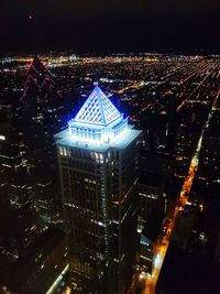 High angle view of illuminated buildings in city at night