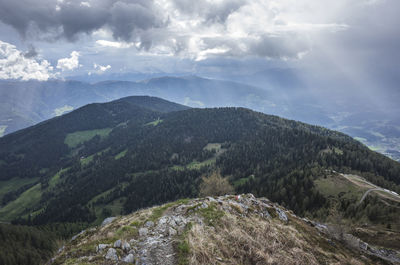 Scenic view of mountains against cloudy sky