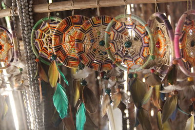 Close-up of decorations hanging for sale in market