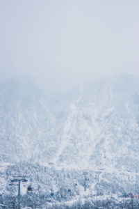 Aerial view of snowcapped mountains against sky