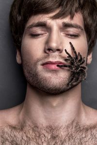 Spider on face of young man