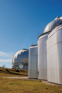 Low angle view of building against clear blue sky