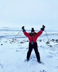 Full length of man standing on snow covered landscape