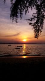 Scenic view of sea against orange sky