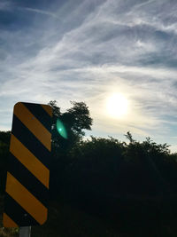 Low angle view of road sign against sky