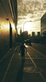 Buildings in city at sunset