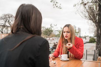 Portrait of young woman with coffee