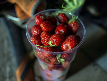 Red ripe strawberries in a glass on the table, macro