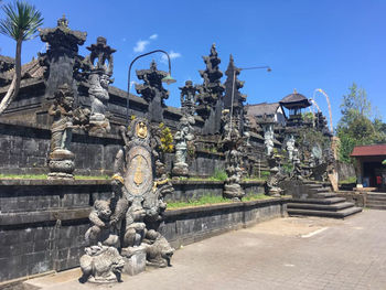 Statue outside temple against building