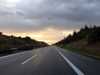 Empty road along countryside landscape