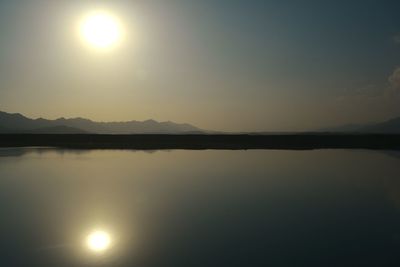 Scenic view of lake against sky during sunset